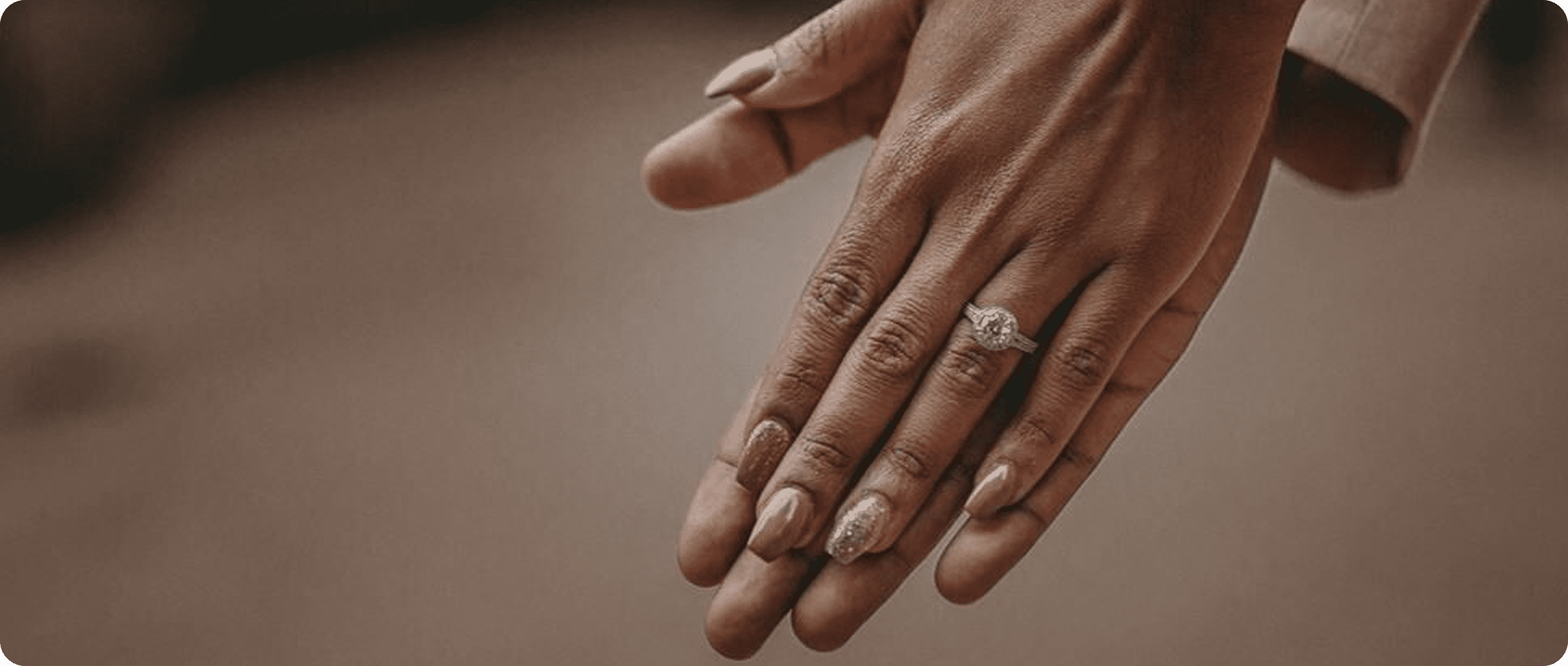 Romantic gesture showing hands and engagement ring.