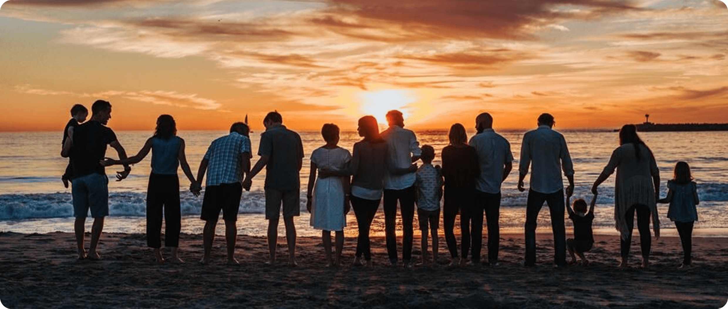 Family enjoying beach sunset together