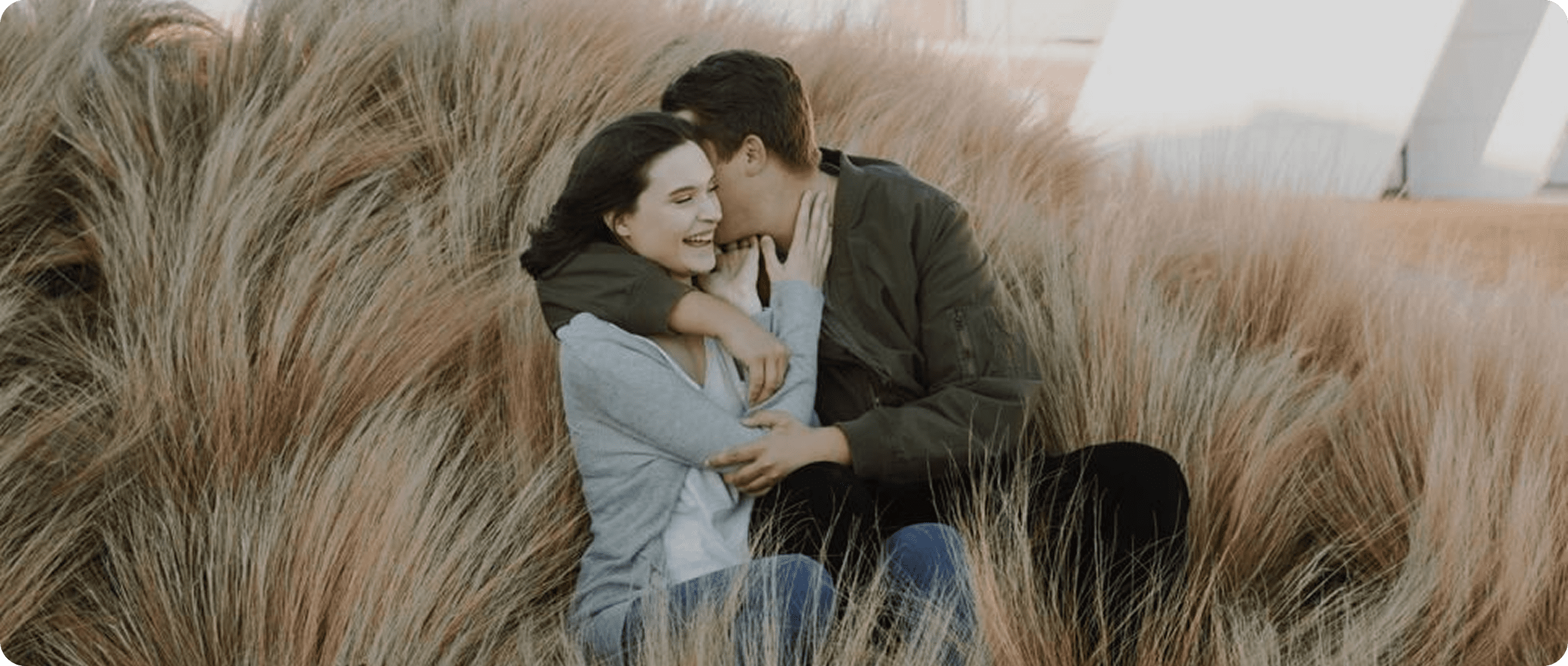 Couple embracing in tall grass