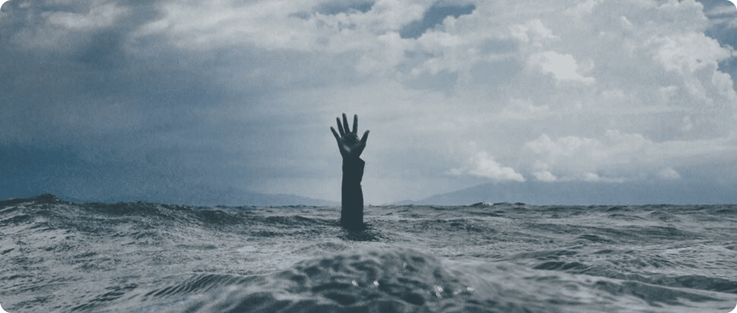 Arm emerging from stormy water
