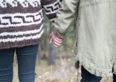 Two people holding hands in autumn